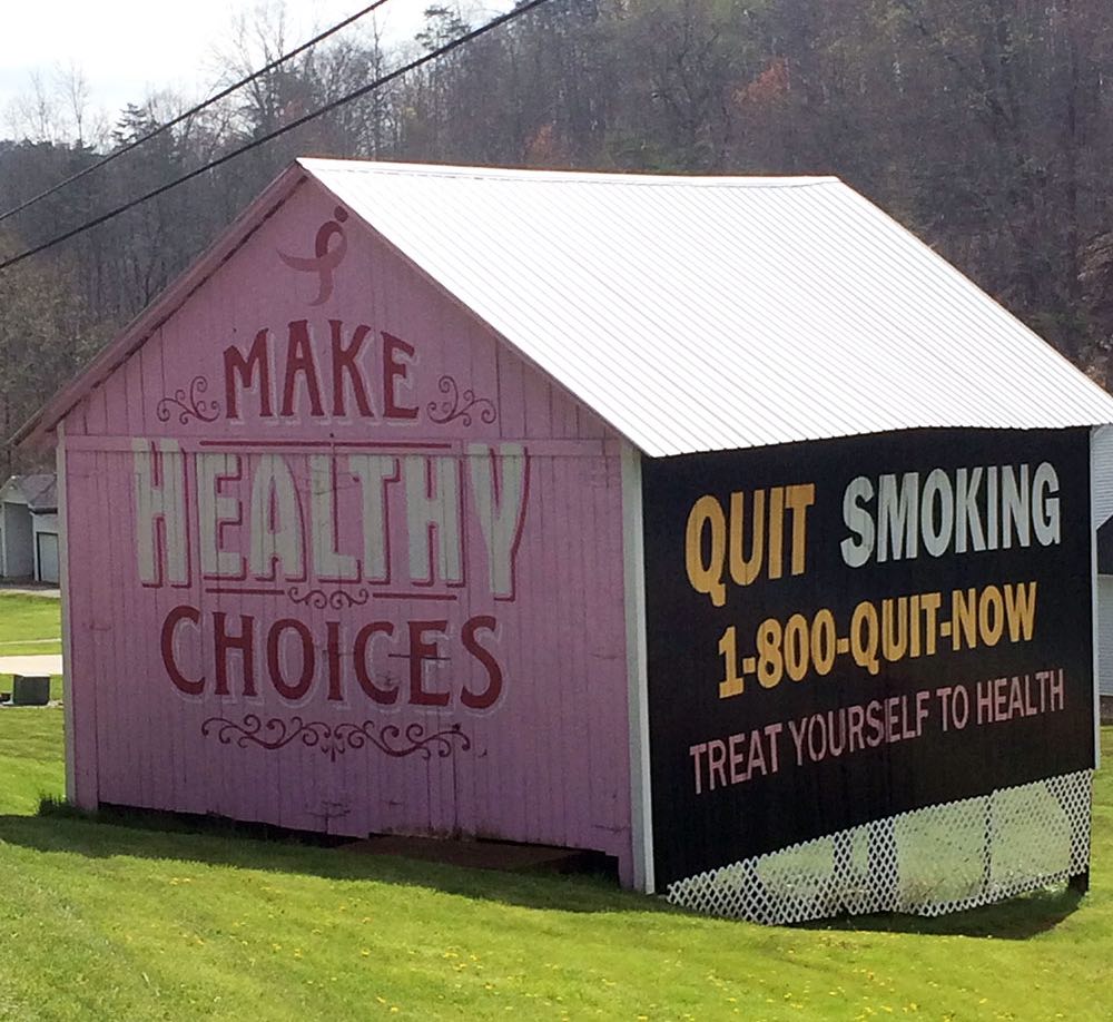 A barn painted with colorful health slogans.